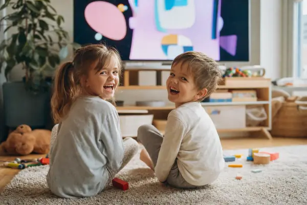 Children laughing while watching cartoons on IPTV