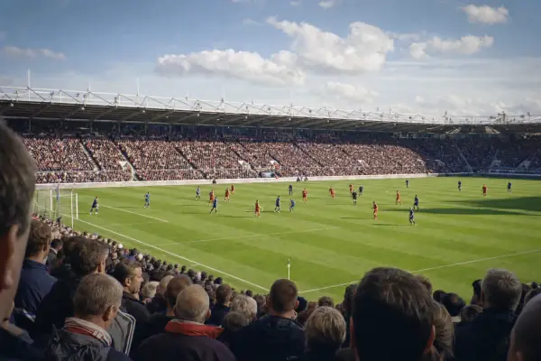 Live football match in a packed UK stadium, streamed on IPTV